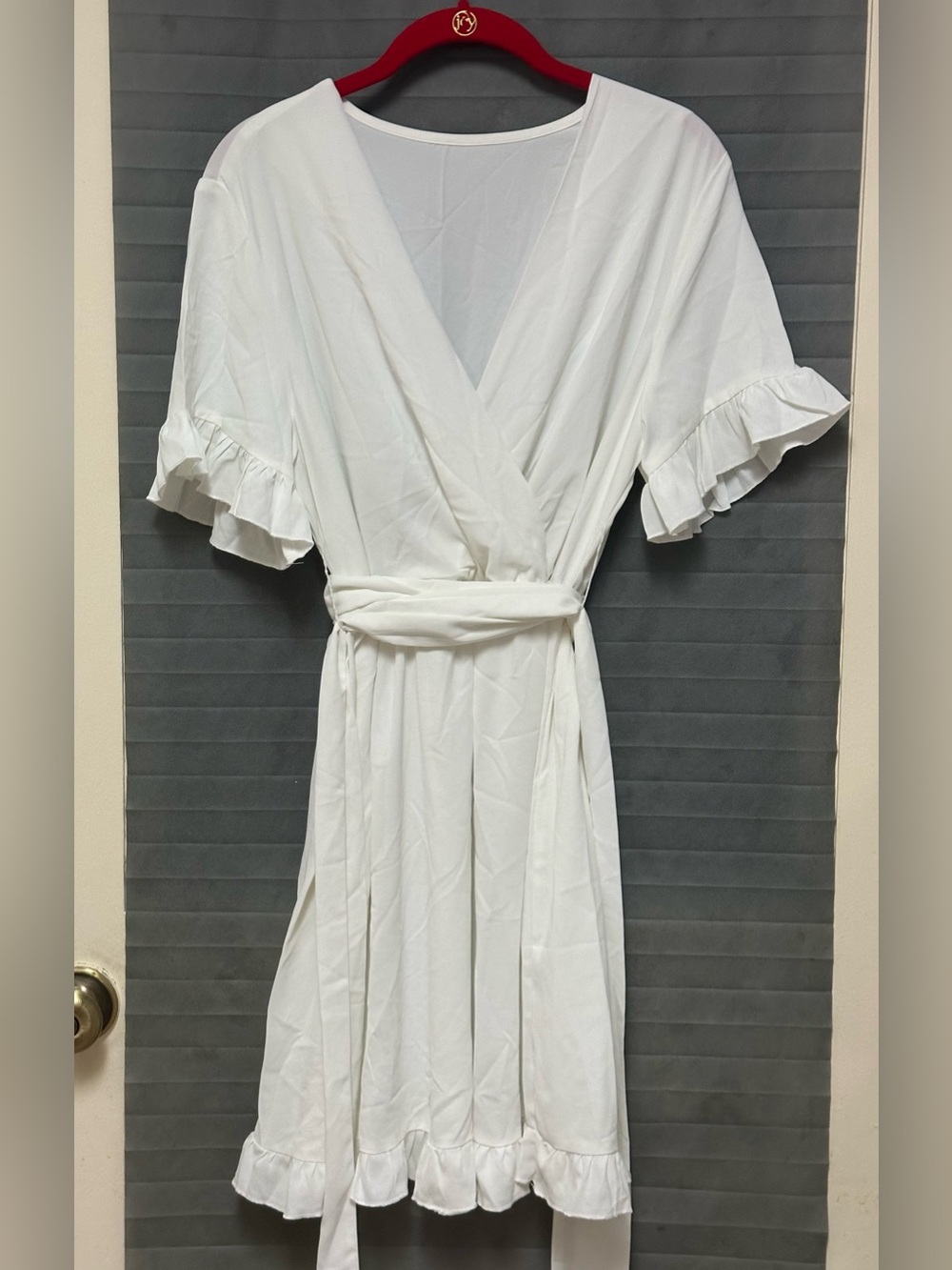 White wrap dress features a deep V-neckline large